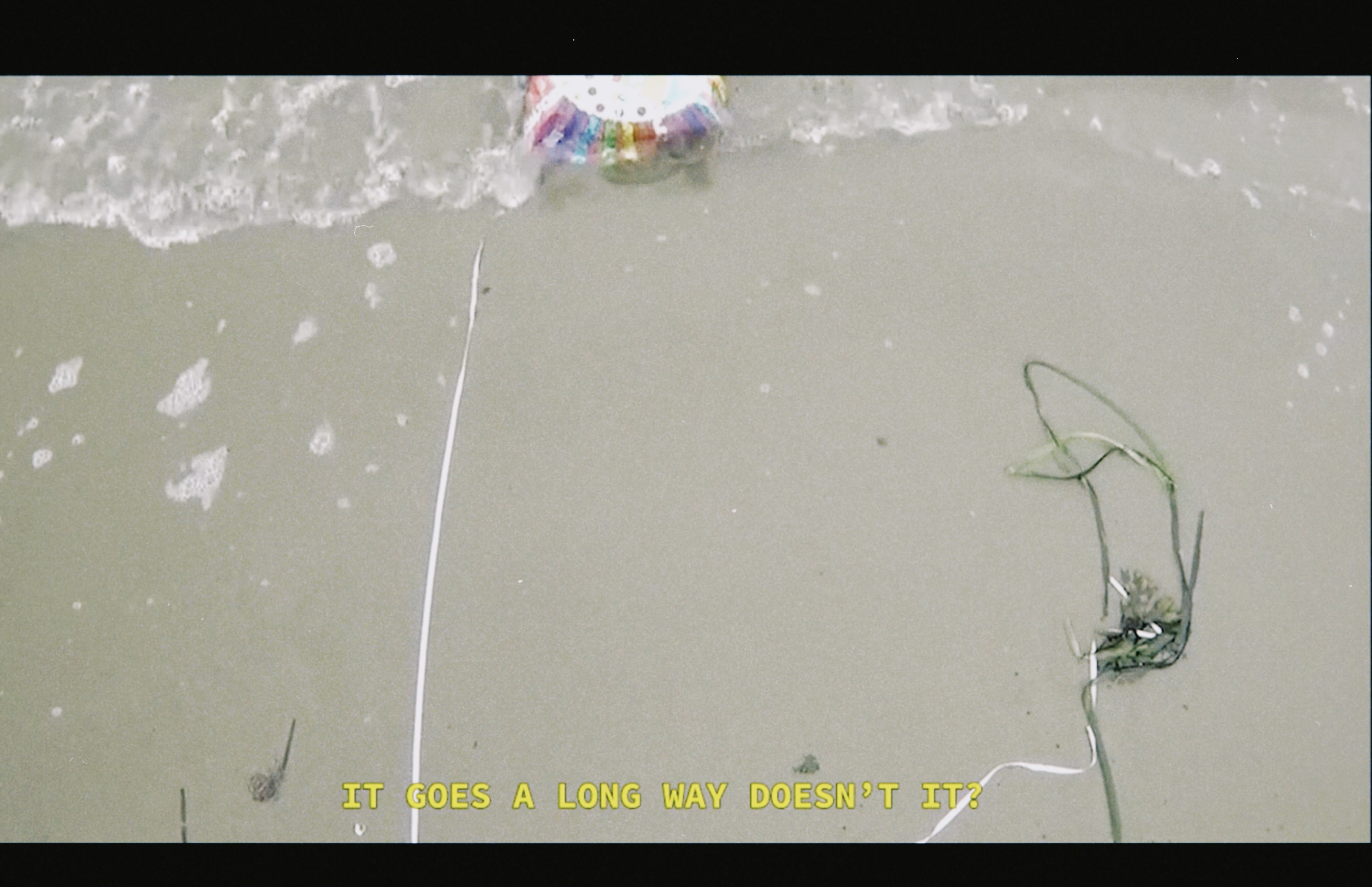 Still from Judgement Proof, Darya Diamond, 2020. SD video on CRTV, cast latex wash bucket.